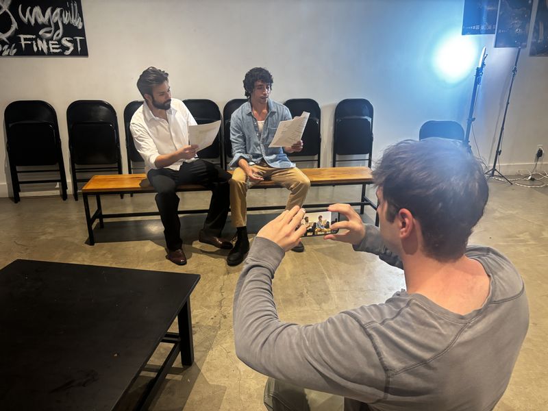 Two actors reading scripts while being filmed on a phone, from Bartow Weiss's project