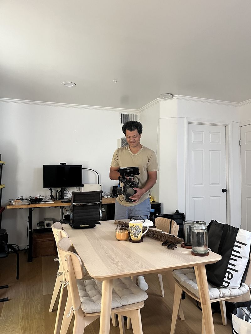 A camera operator setting up a shot in an apartment, from Daniel Smith Coleman's project