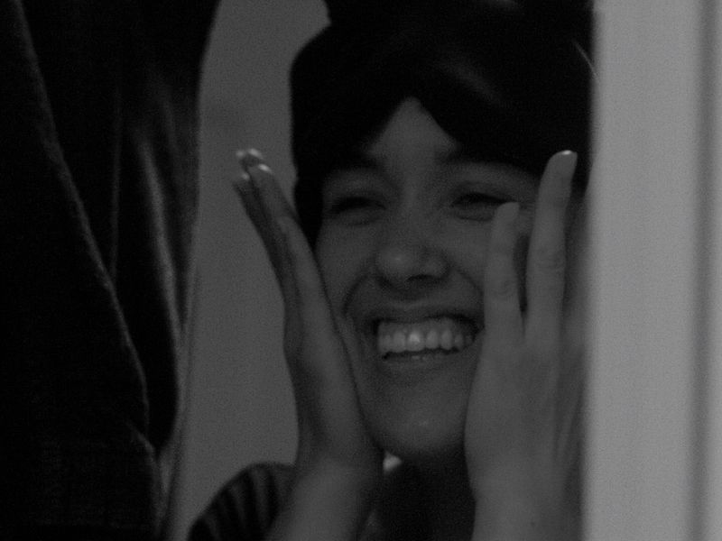 A black-and-white still of an actor laughing, from Daniel Smith Coleman's project