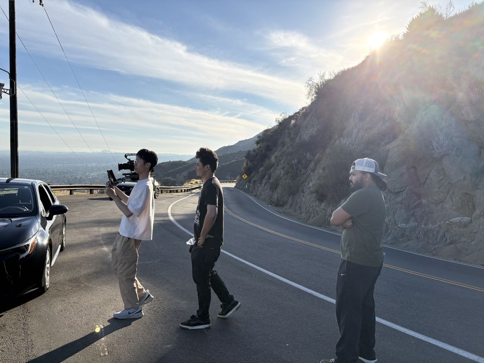 Erik Dylan Matibag's crew with a camera rig on a mountain road, backlit by late sun